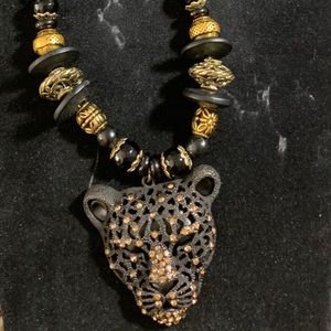 Enjoy a black and gold black panther necklace